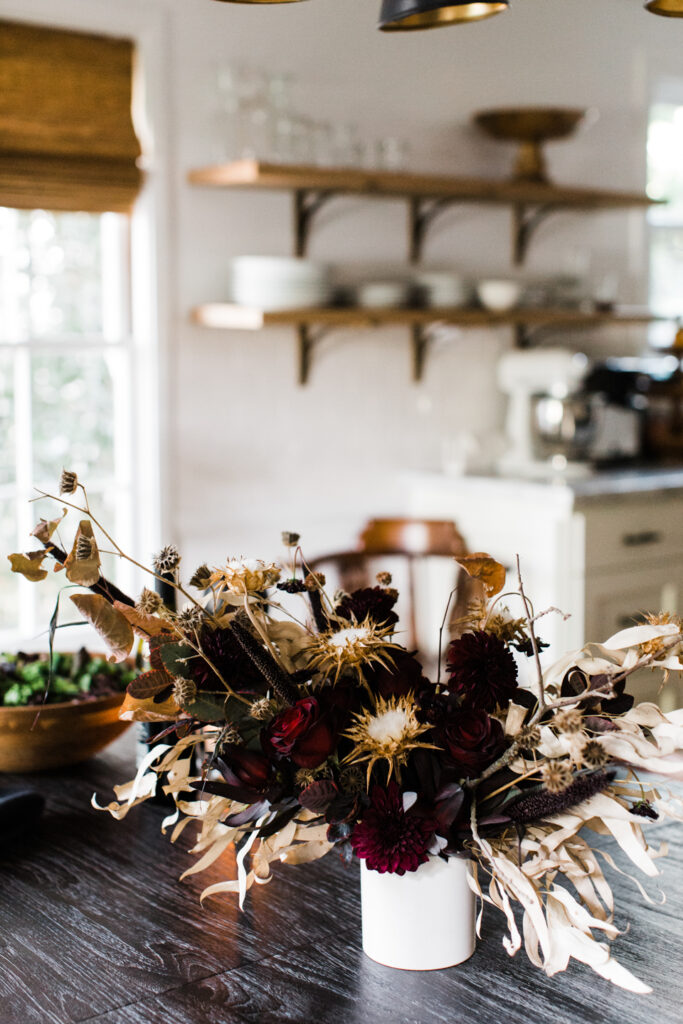 12 Stunning Halloween Florals to Inspire a Spooky Event / Dried floral arrangement with dark red flowers