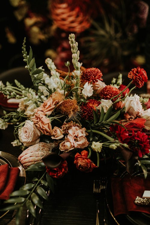 12 Stunning Halloween Florals to Inspire a Spooky Event / Fall floral arrangement with shades of orange 