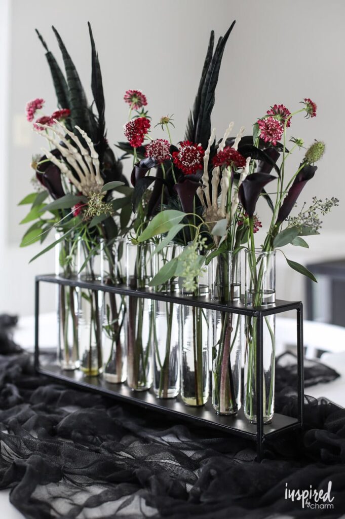 12 Stunning Halloween Florals to Inspire a Spooky Event / Tube centerpiece with moody flowers